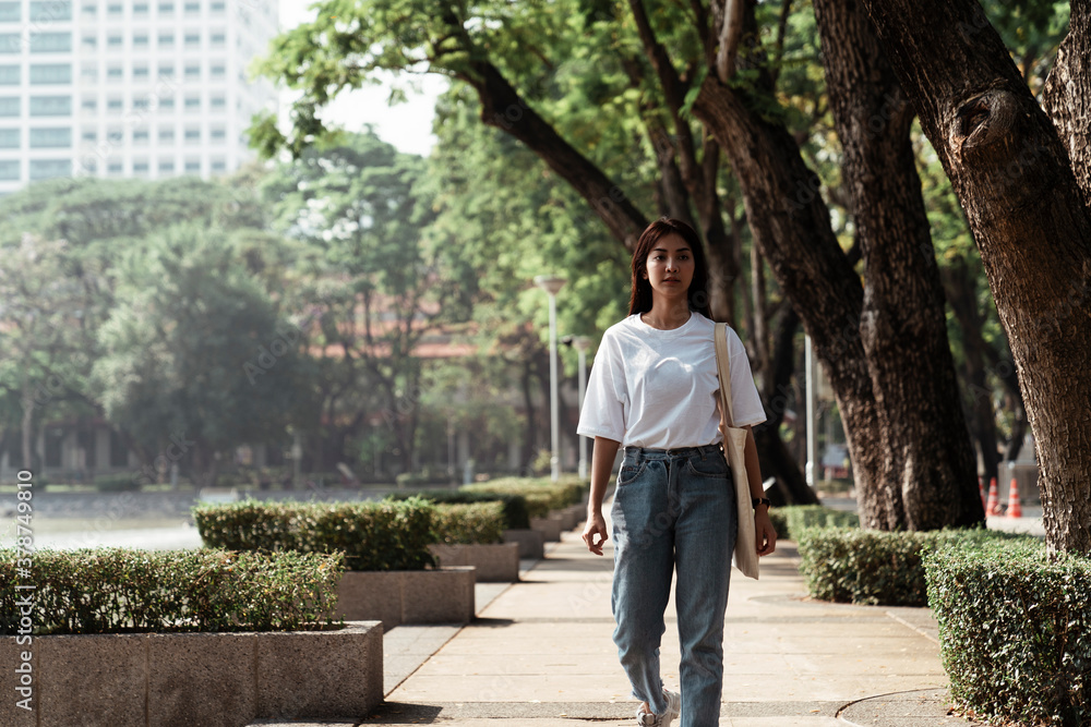 University student walking in the park.