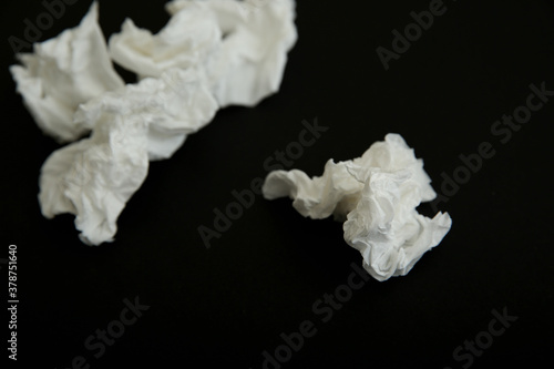 Used white paper tissues on black background
