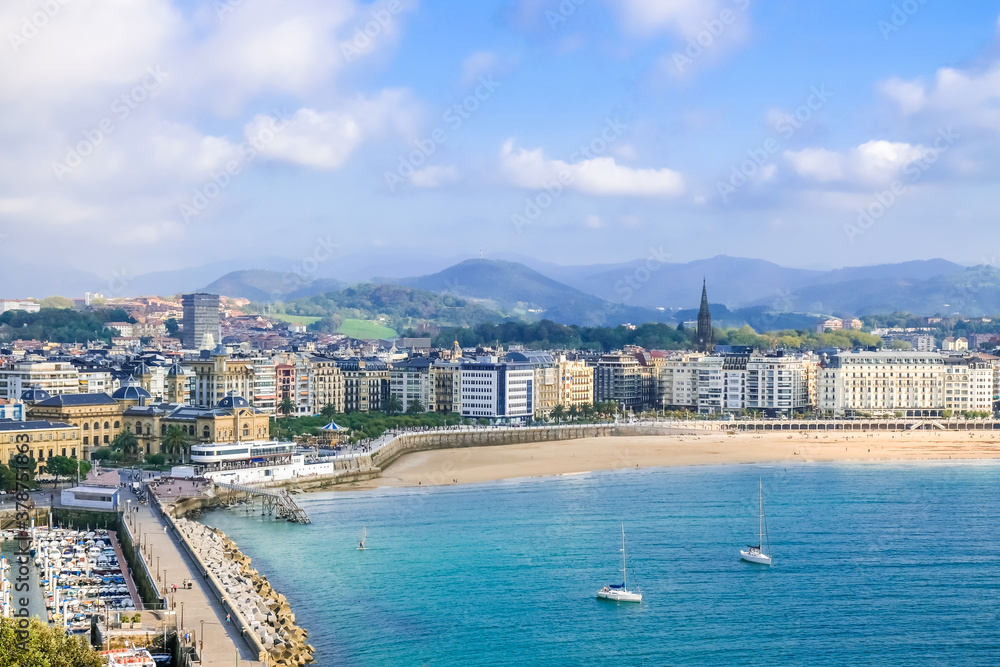 beautiful sunset view of sandy beach and marina in the city center Donostia San Sebastian in the Bay of Biscay, Basque Country, Spain