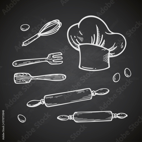 Hand drawn kitchen set. Vector illustration isolated on chalkboard background. Collection of kitchen stuff: chef hat, wooden sparula and fork, culinary whisk and rolling pin. 