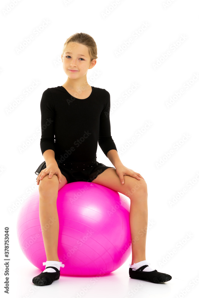 little girl doing exercises on a big ball for fitness. little girl doing exercises on a big ball for fitness.