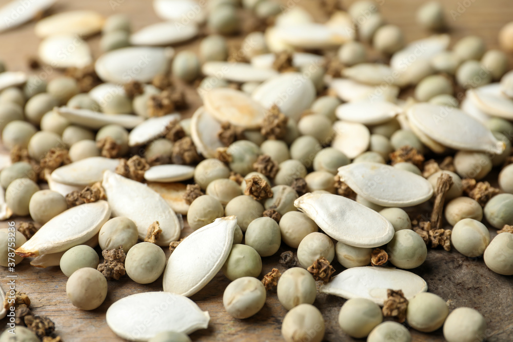 Mixed vegetable seeds on wooden background, closeup