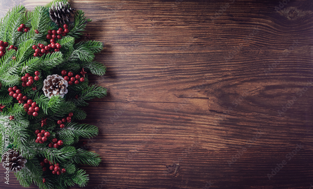 Christmas branches decoration concept with berries, stars and pine cones on old wooden background. Flat lay, top view with copy space. Christmas branches decoration concept with berries, stars and pine cones on old wooden background. Flat lay, top view with copy space.