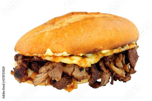 Steak and cheese sandwich with fried onions in a crusty bread roll isolated on a white background
