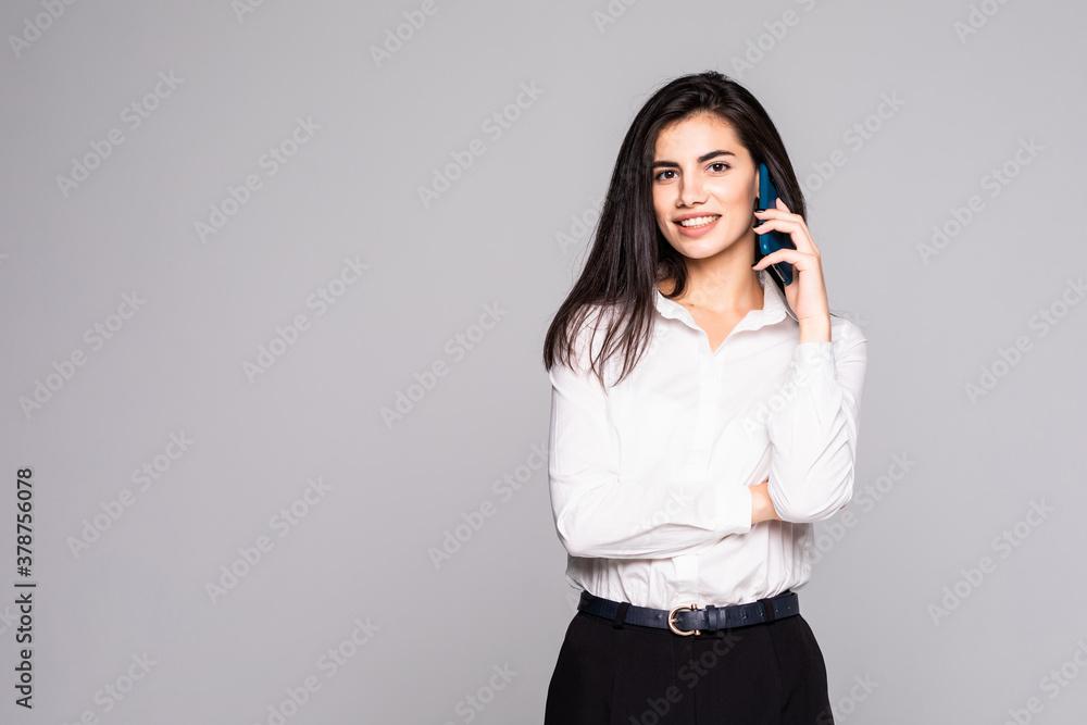 Businesswoman walking talking on mobile phone, isolated on white background Businesswoman walking talking on mobile phone, isolated on white background