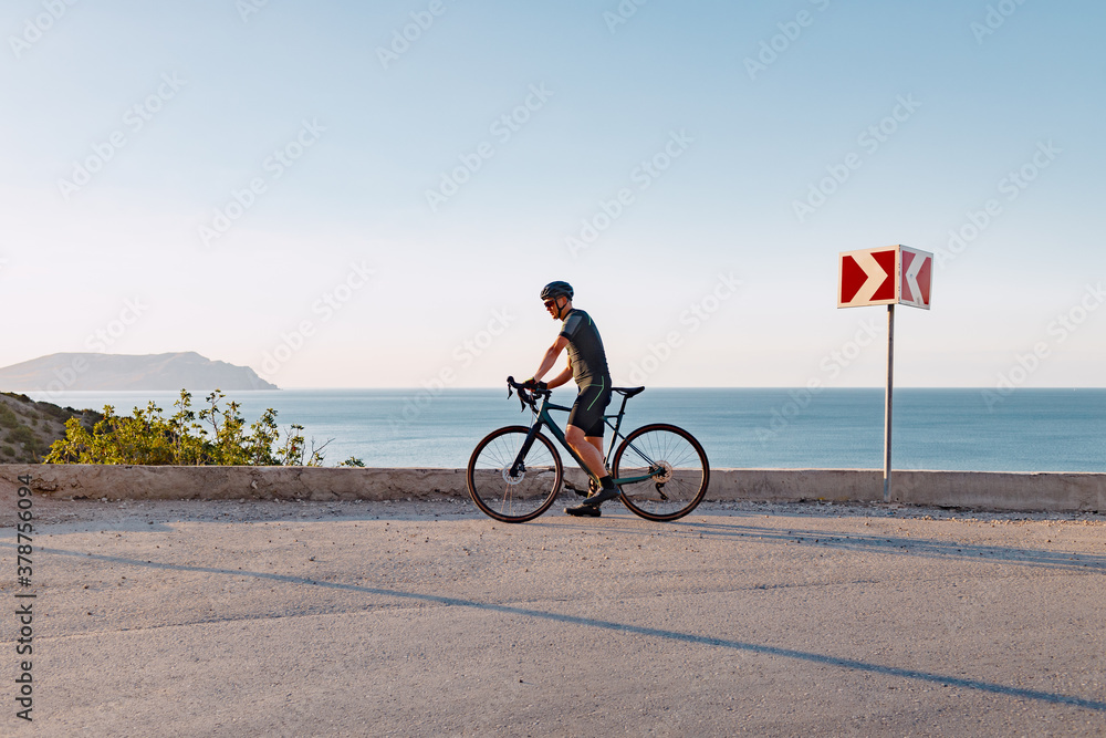 Fototapeta premium Professional road bicycle racer in action on mountain road