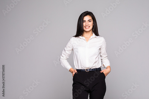 Portrait of young busineswoman standing over white background.
