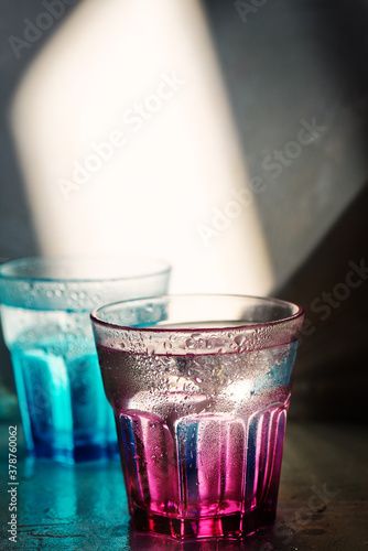 Glass of water on arustic backreound. with lighting effects photo