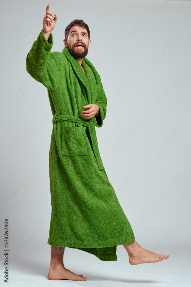 emotional man in a green robe on a light background in full growth fun emotions model emotional man in a green robe on a light background in full growth fun emotions model