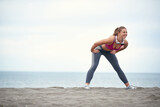 Young girl doing fitness on the beach
