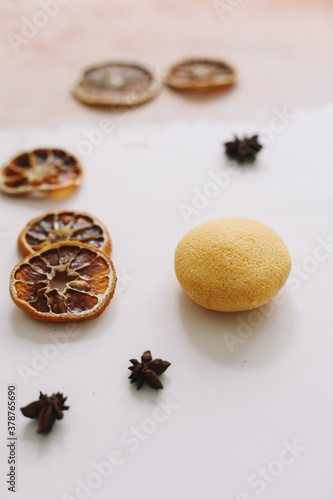 Natural soap with dried slices of oranges on a white background. Handmade soap and ingredients. Flat lay. Space for text, top view