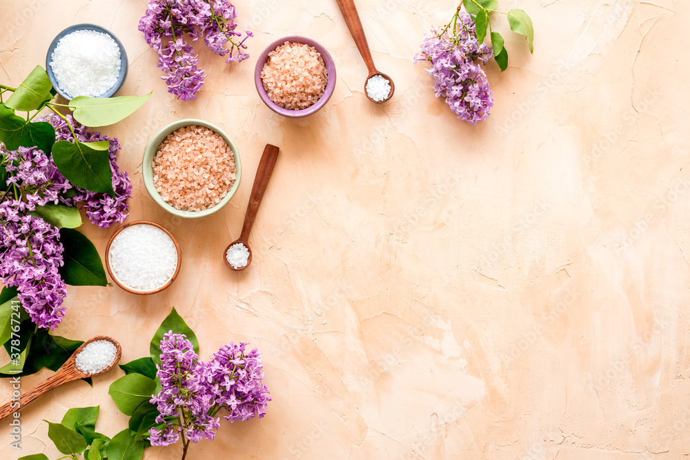 Spa treatment set - sea salt and pink flowers, top view Spa treatment set - sea salt and pink flowers, top view