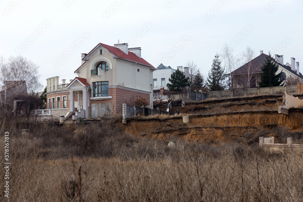 landslide caused by torrential rains of hurricane CHRISTIE. Broken road asphalt cracked, and came down with landslide. Destroyed residential buildings of cottage town elite settlement. earthquake landslide caused by torrential rains of hurricane CHRISTIE. Broken road asphalt cracked, and came down with landslide. Destroyed residential buildings of cottage town elite settlement. earthquake