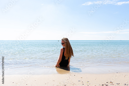 Woman enjoying her holidays at the tropical beach. Happy young woman enjoys her beach vacation