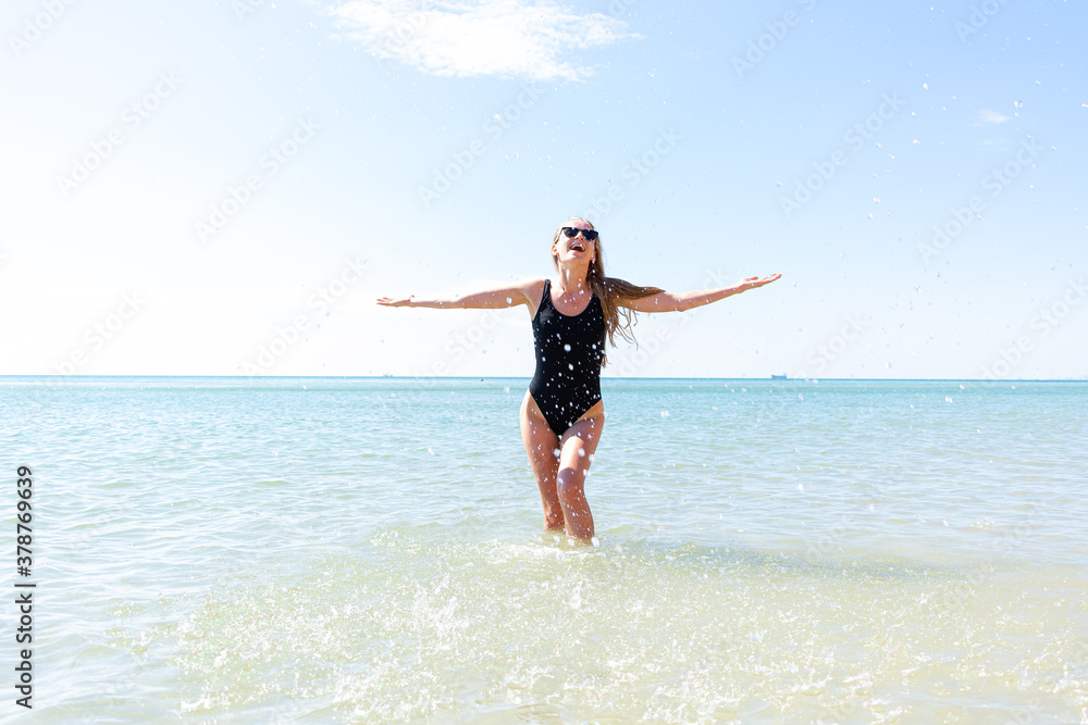 Woman enjoying her holidays at the tropical beach. Happy young woman enjoys her beach vacation Woman enjoying her holidays at the tropical beach. Happy young woman enjoys her beach vacation
