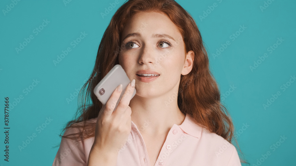 Beautiful girl recording voice message on smartphone over colorful background Beautiful girl recording voice message on smartphone over colorful background