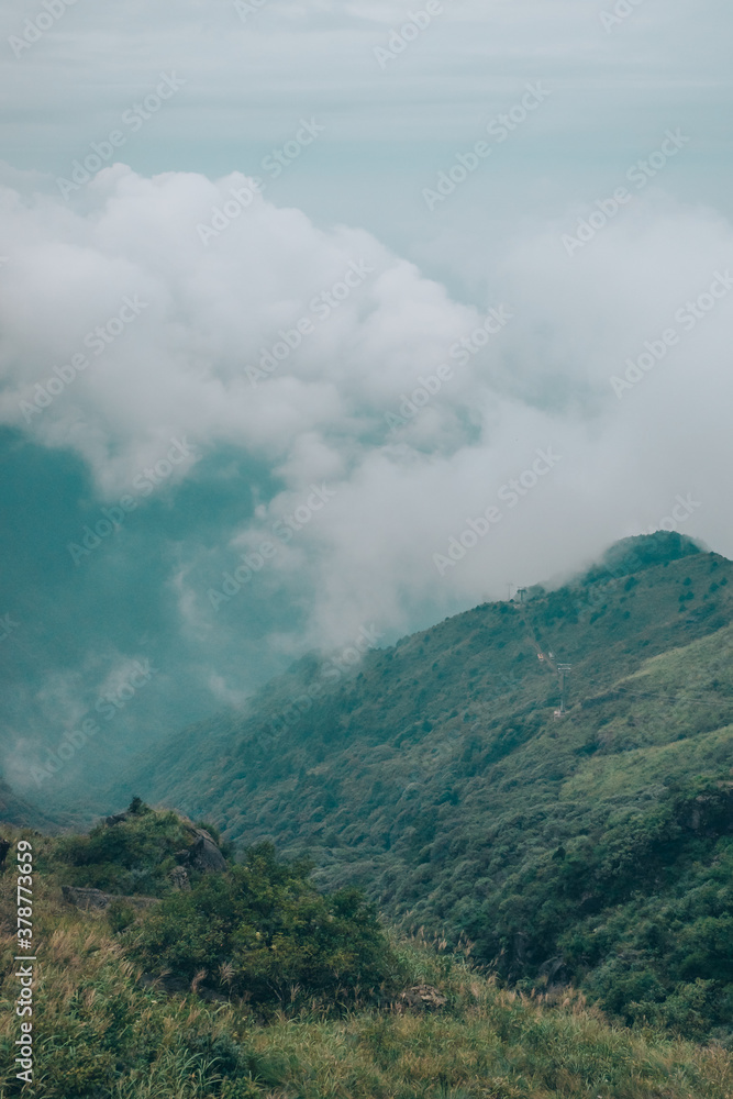 Meadow landscape with mountains covered by clouds on Wugong Mountain in Jiangxi, China
