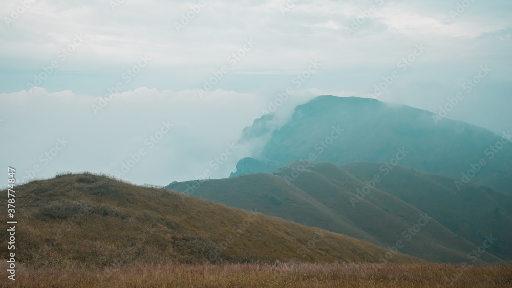 Grassland on mountain ridge covered in clouds on Wugong Mountain in Jiangxi, China