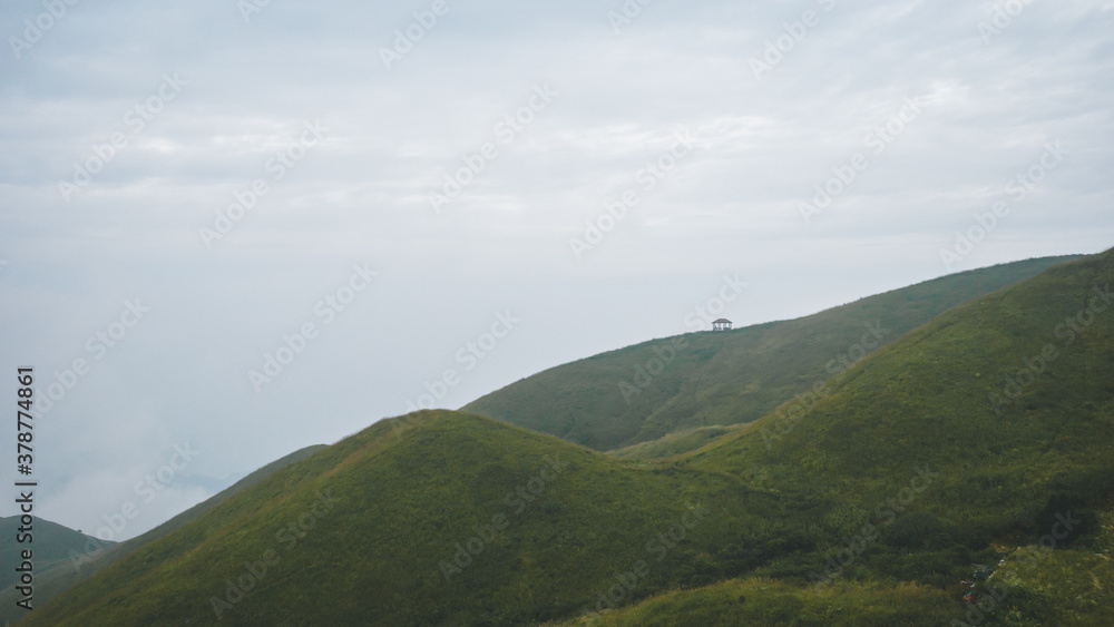 Grassland on mountain ridge covered in clouds on Wugong Mountain in Jiangxi, China Grassland on mountain ridge covered in clouds on Wugong Mountain in Jiangxi, China