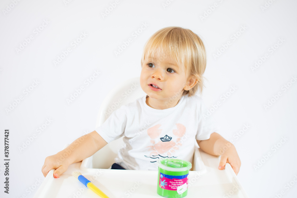 Amazed toddler boy with colorful paints on face isolated on white background Amazed toddler boy with colorful paints on face isolated on white background