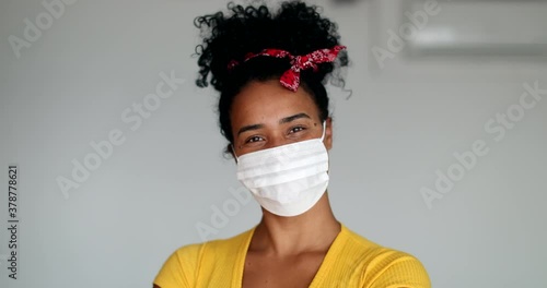 African amercian young woman putting virus prevention face mask photo