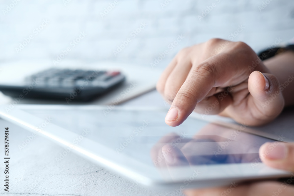 Close up of women hand analyzing bar charts on digital tablet Close up of women hand analyzing bar charts on digital tablet
