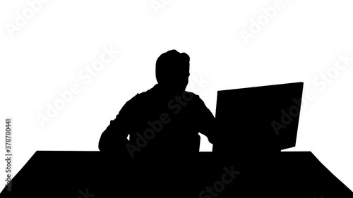 Silhouette Nervous man watching video games on a PC computer. photo