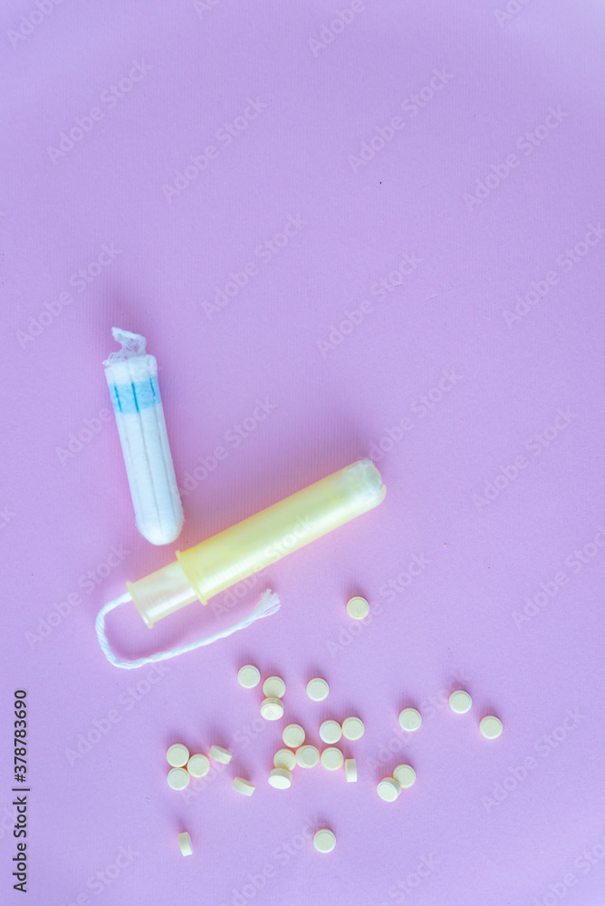Tampons and pills on a pink background. Concept for medecine.
Tampons and pills on a pink background. Concept for medecine.