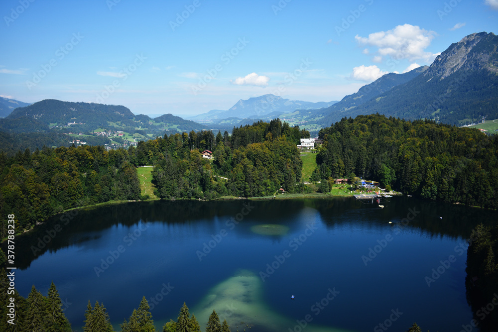 a top view of green lake Freibergsee at Alp mountains near Oberstdorf