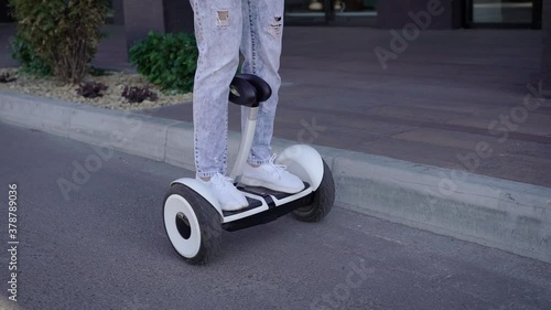 Wallpaper Mural A man rides hoverboard on a city road. Modern elestro transport is convenient and environmentally friendly. Torontodigital.ca