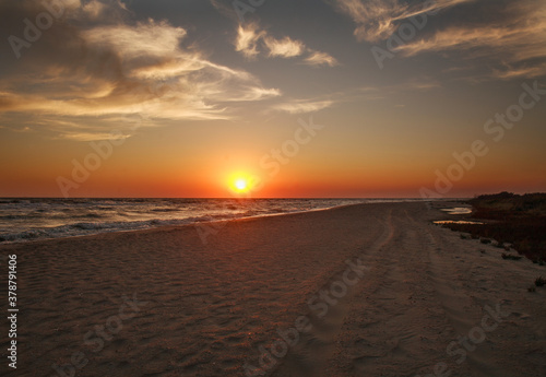 Beautiful sunset in sky  sandy beach on the sea coast