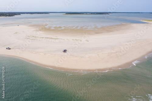 The Atlantic Ocean washes onto a scenic, sandy beach on Cape Cod, Massachusetts. This scenic peninsula is a popular summer vacation destination in New England. photo