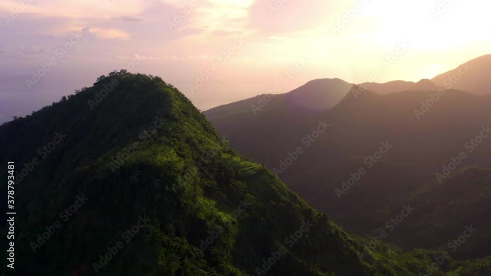 Multicolored sunrise at tropical mountains in Indonesia with picturesque views Multicolored sunrise at tropical mountains in Indonesia with picturesque views