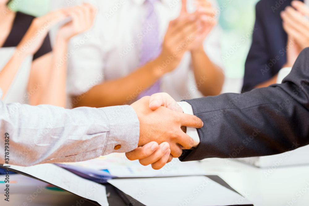 Business people shaking hands, finishing up a meeting.