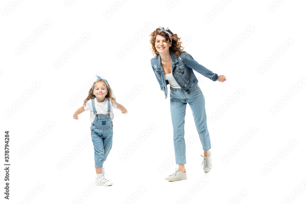 mother and daughter in denim outfits posing and smiling isolated on white mother and daughter in denim outfits posing and smiling isolated on white