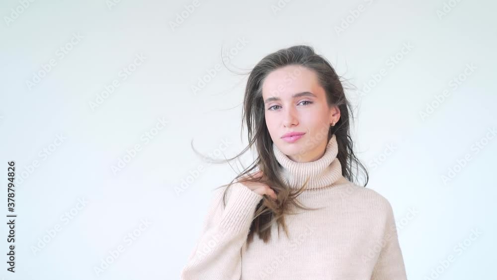 close up portrait of a young attractive woman on a white background. face a beautiful fashion female model poses and looks a camera and smiles. Exquisite lady isolated in studio. health and beauty close up portrait of a young attractive woman on a white background. face a beautiful fashion female model poses and looks a camera and smiles. Exquisite lady isolated in studio. health and beauty