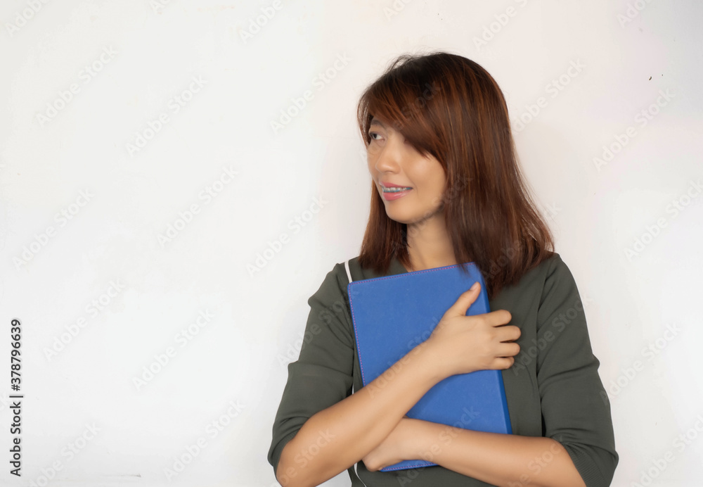 Lady wearing braces,hugging book in her arm and smile,with happy feeling,model posing Lady wearing braces,hugging book in her arm and smile,with happy feeling,model posing