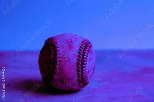 Bright baseball on neon background for sport.