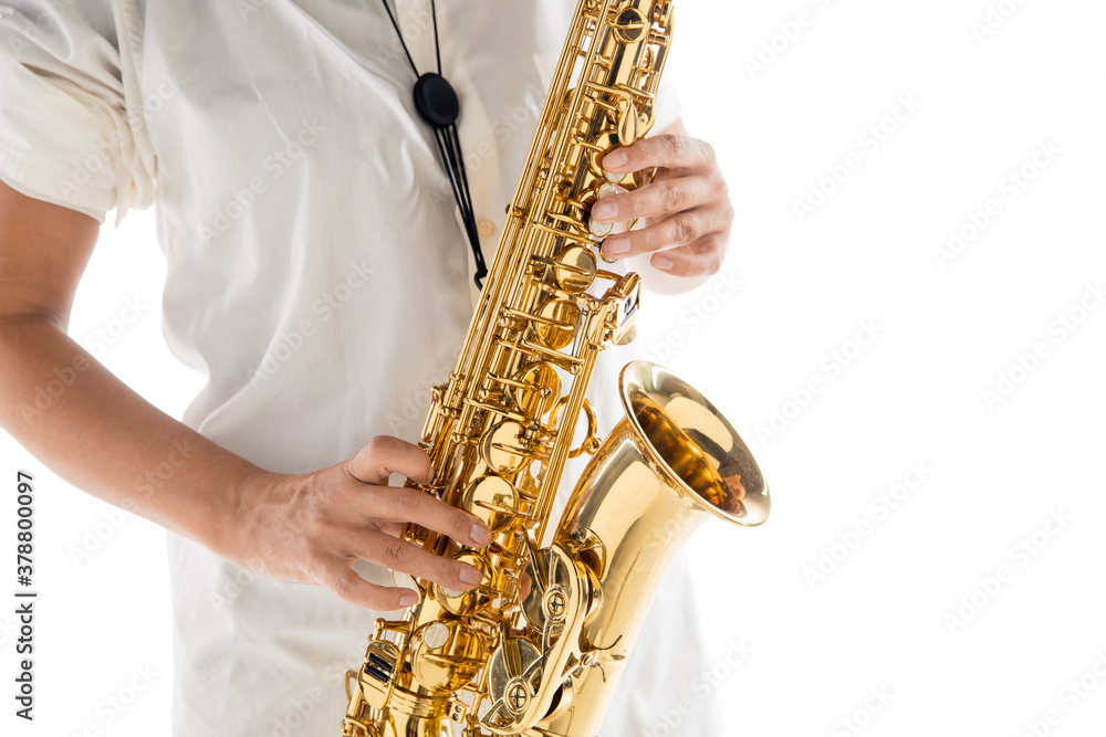 Fototapeta premium Close up woman playing saxophone isolated on white studio background. Inspired musician, details of art occupation, world classic instrument for jazz and blues. Concept of hobby, creativity.