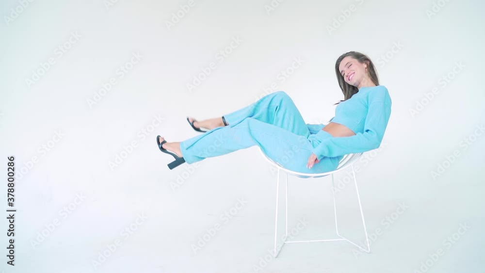 full length portrait Professional fashion model in stylish blue suit posing on camera in studio. Isolated white background. Concept of confidence and female beauty young woman girl. Copy space text full length portrait Professional fashion model in stylish blue suit posing on camera in studio. Isolated white background. Concept of confidence and female beauty young woman girl. Copy space text