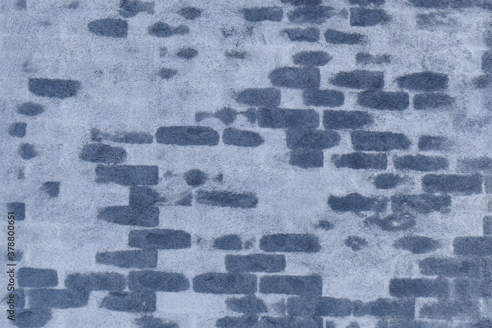 The brick wall is covered with blue plaster.