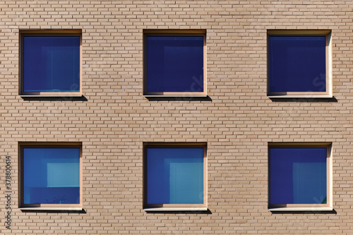 Obraz na płótnie The blue windows in the brick wall. Modern Nordic architecture. w salonie