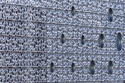 Obraz na płótnie The metal wall of a modern building with circle windows. w salonie