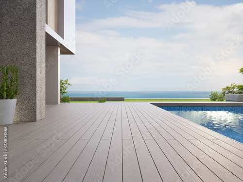 Empty outdoor wooden floor terrace near swimming pool and green grass garden in modern beach house or luxury villa. Building exterior 3d rendering with sea view.
