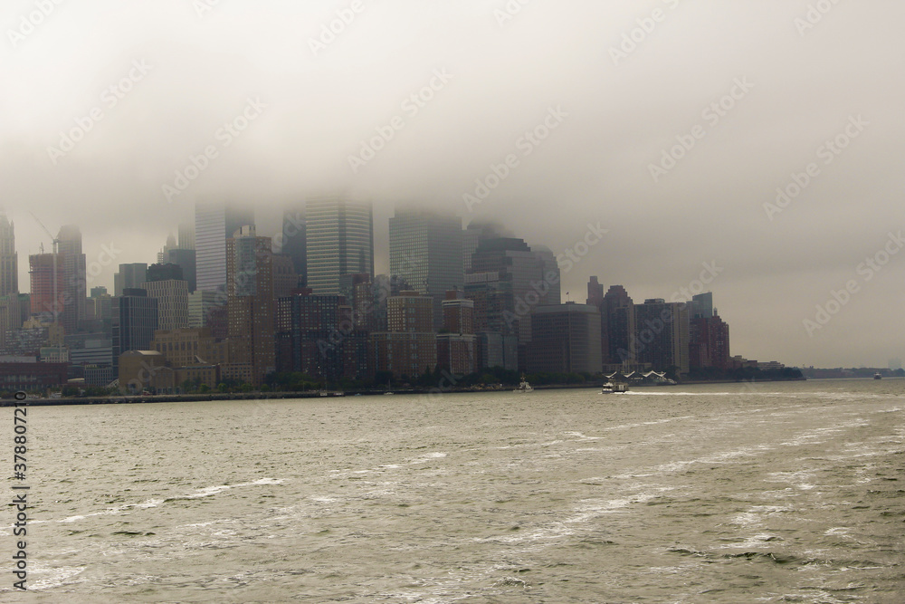 Views of Manhattan from the deck of a cruise ship during a misty day