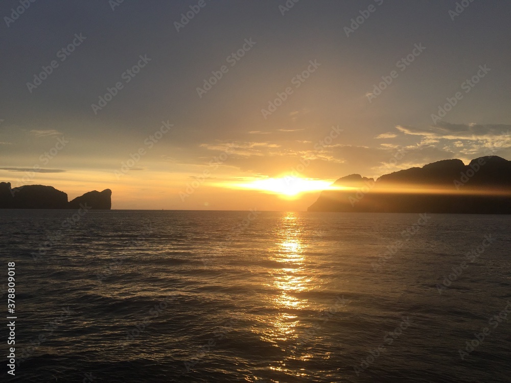 Extreme sunset view from the ocean in Thailand Phi Phi Islands Asia with mountains in the background 