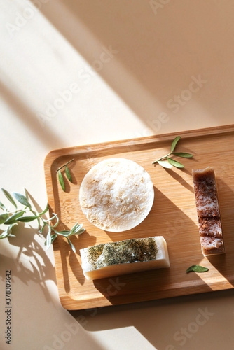 Wooden tray with handmade soap from natural ingredients. Warm background with highlights from the sun on the theme of natural cosmetics.