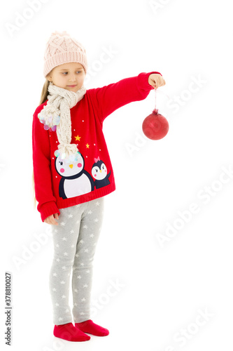 Little girl with Christmas tree toy. © lotosfoto