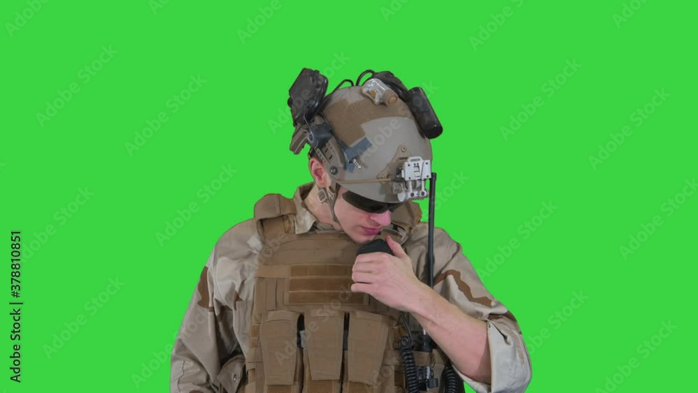 Soldier talking on the radio on a Green Screen, Chroma Key. Soldier talking on the radio on a Green Screen, Chroma Key.