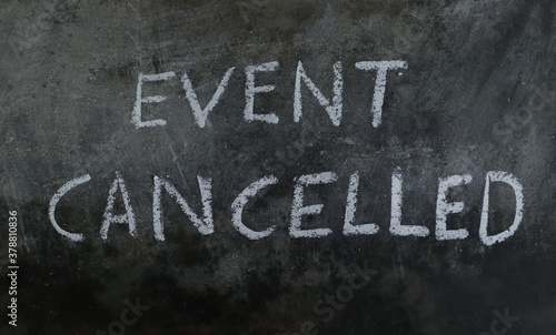 Event Cancelled Phrase Written on Blackboard with White Chalk